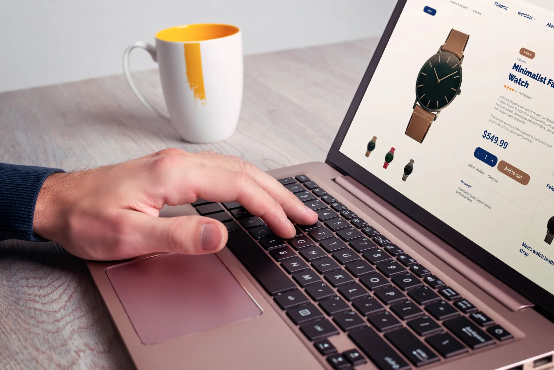 Hands on a laptop showing a watch product page