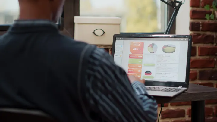 Someone studying a dashboard of charts on a laptop